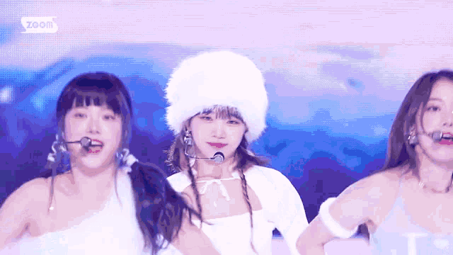 a group of young women are standing next to each other on a stage .