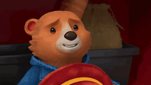 a teddy bear wearing a blue shirt and a red hat