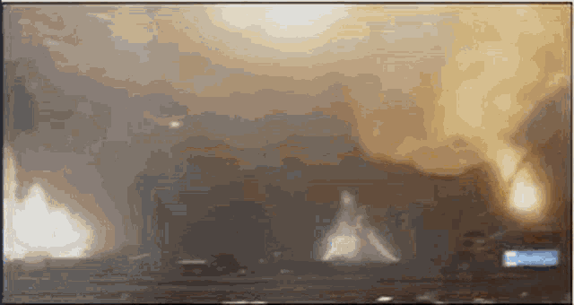 a tv screen shows a huge explosion with smoke coming out of it