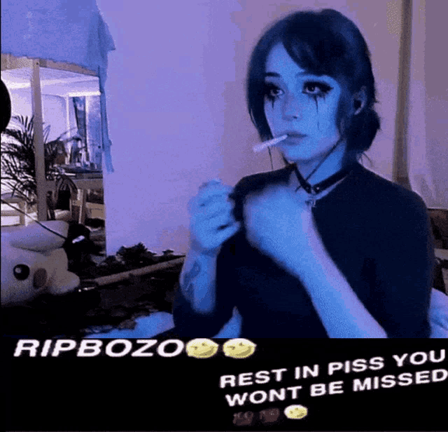 a girl smoking a cigarette with the words rip bozo rest in piss you won t be missed