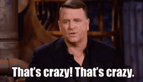 a man in a suit is sitting in a chair and saying `` that 's crazy ! that 's crazy ! ''