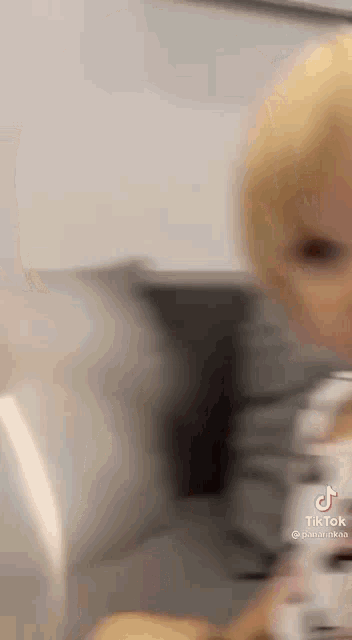a close up of a baby 's face while sitting on a couch .
