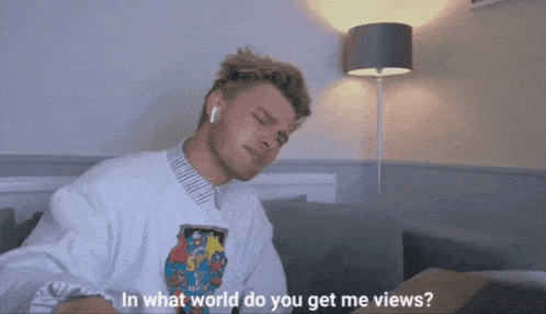 a man is sitting on a couch with his eyes closed and the words in what world do you get me views on the screen