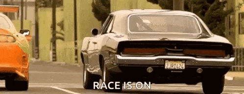 a dodge charger is driving down a street next to another car and the words `` race is on '' are visible .