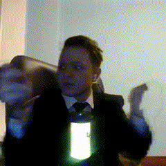 a man in a suit and tie is holding a lantern in his right hand