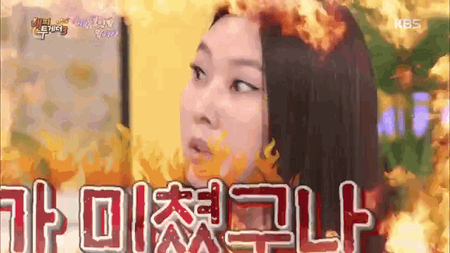 a woman with fire coming out of her hair is talking to someone in a foreign language .