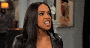 a woman wearing a black leather jacket making a funny face