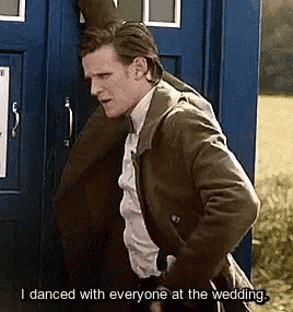 a man leaning against a blue box with the words i danced with everyone at the wedding written below him