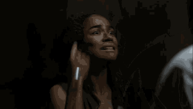a woman is covering her face with her hands