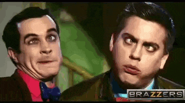 two men are making funny faces in front of a brazzers sign .