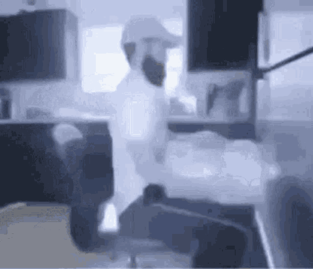 a man with a beard is sitting in an office chair .