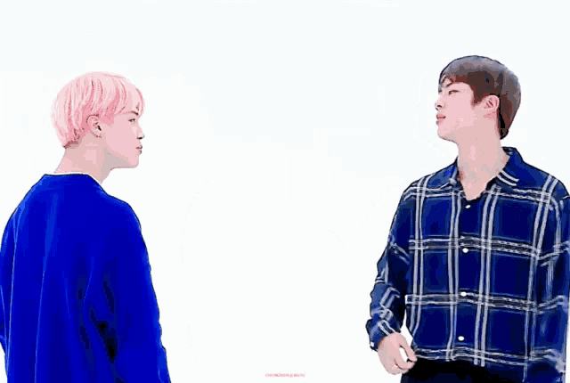 a man with pink hair is touching another man 's hand