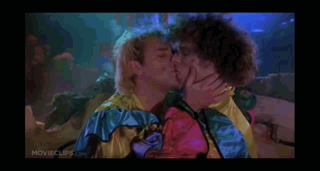 a couple of men are kissing each other in a movie .