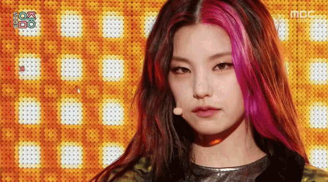 a close up of a woman 's face with a microphone and the letters mbc on the bottom
