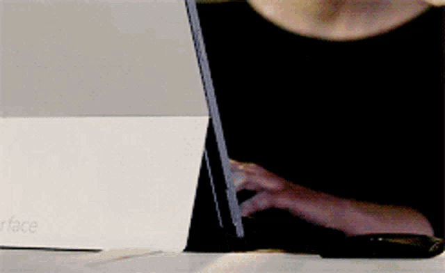 a person is typing on a laptop that says google