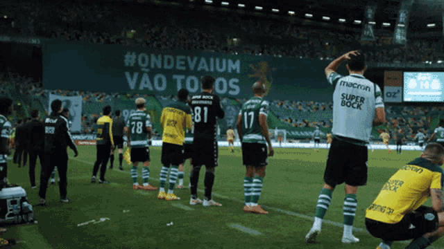 soccer players on a field with a banner that says #ondevaium vao tolos