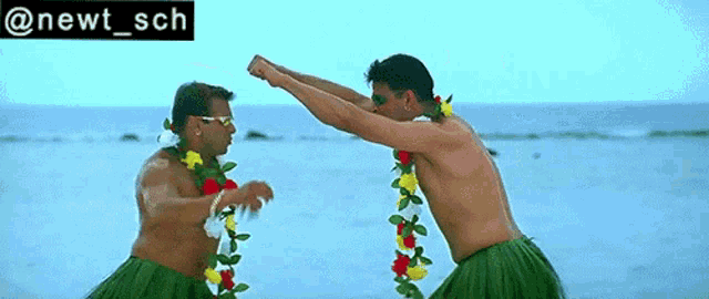 two men wearing hula skirts are dancing on a beach with the words @newt_sch above them