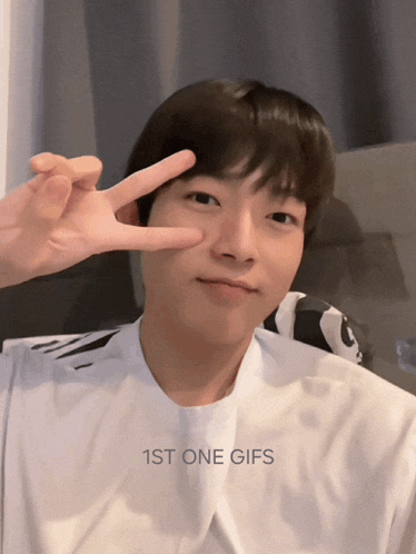 a young man giving a peace sign with the words 1st one gifs behind him