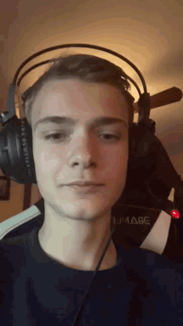 a man wearing headphones with the word image on the back