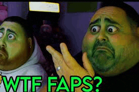 a man with a green face is making a funny face while holding a cell phone .
