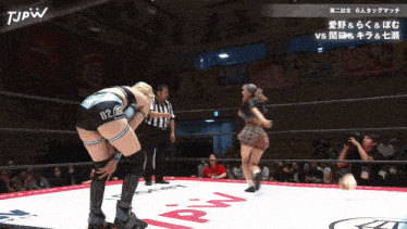 two women are wrestling in a ring with jpw written on the bottom