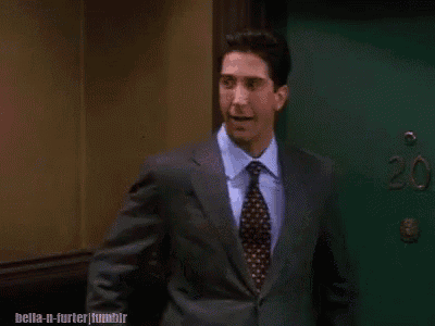 a man in a suit and tie is standing in front of a green door that says 20