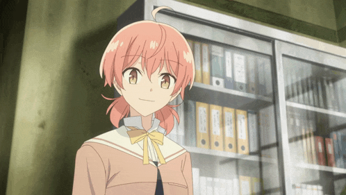 a girl with pink hair is standing in front of a shelf with binders on it