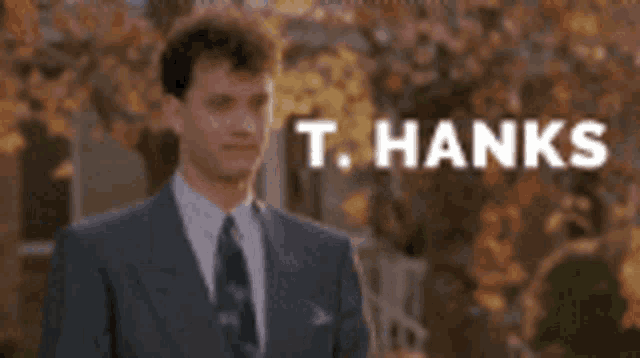 a man in a suit and tie is saying thanks