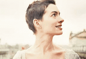 a close up of a woman 's face with short hair .