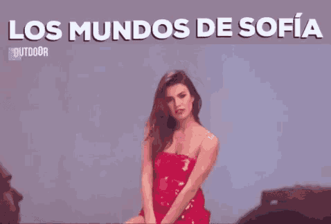 a woman in a red dress is dancing with the words los mundos de sofia behind her