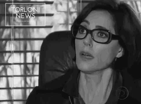 a black and white photo of a woman wearing glasses with the words torloni news written above her