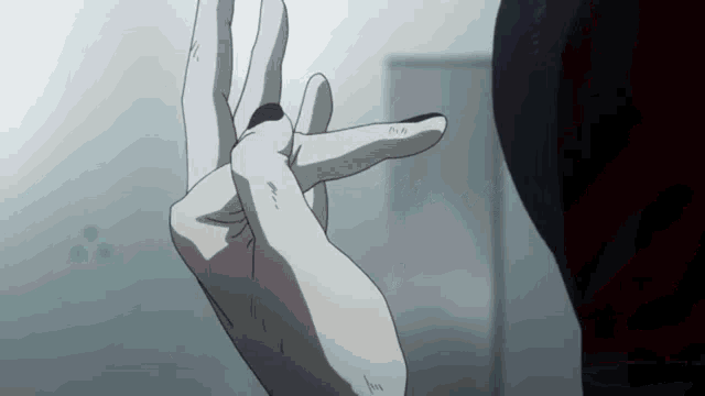 a close up of a person 's hand with black nails
