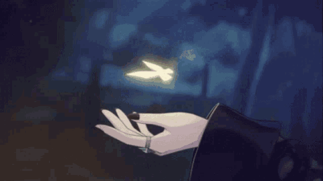 a person holding a butterfly in their hand with a purple background