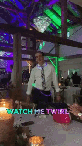a man in a white shirt and tie is dancing in a room with the words watch me twirl on the bottom