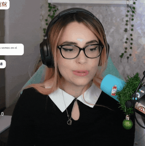 a woman wearing glasses and headphones has a sticker on her ear that says " vemos en el "