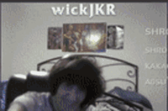 a person sitting in front of a screen with the name wickjkr on it