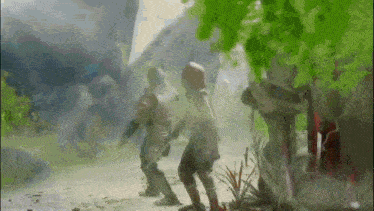 a couple of people are standing on a dirt road in a foggy forest .