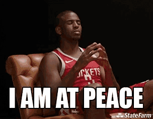 a basketball player is sitting in a chair with his eyes closed and the words `` i am at peace '' above him .