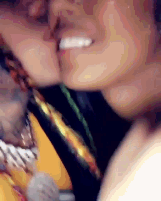 a close up of a person 's mouth with a yellow shirt on