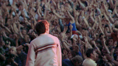 a man is standing in front of a crowd of people