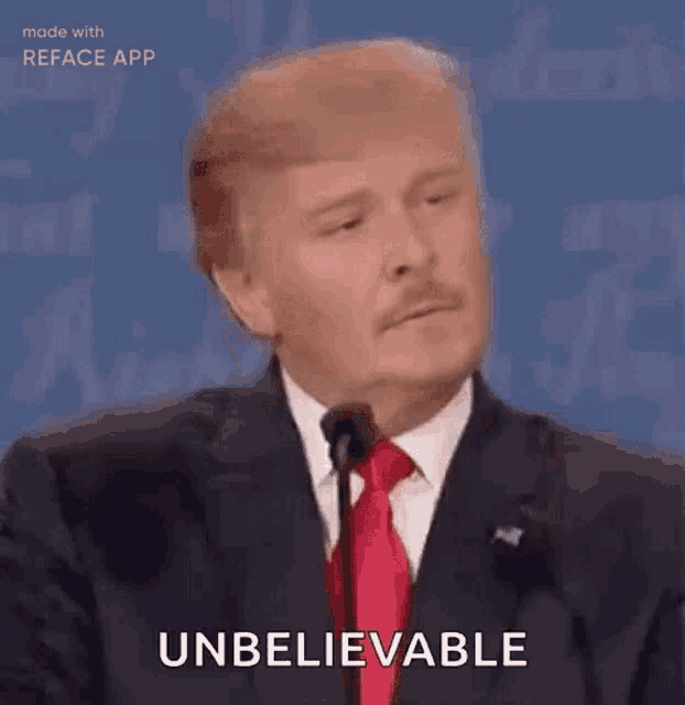 a man in a suit and tie is giving a speech at a debate .