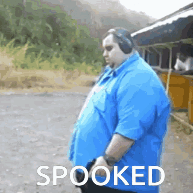a man in a blue shirt with the word spooked on the bottom