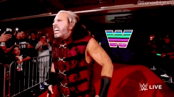 a wrestler named matt hardy is standing in the ring with his arms outstretched