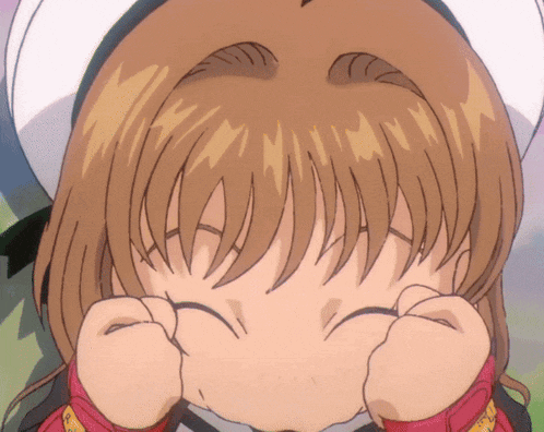 a close up of a girl making a face with her hands