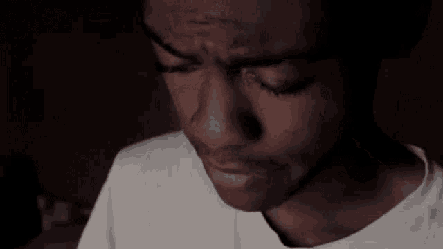 a young man wearing a white hat and a white shirt looks at something