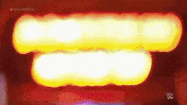 a blurred image of a red and yellow light with a wrestling logo in the corner .