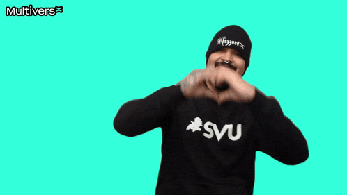 a man making a heart shape with his hands in front of a green background that says multiverse