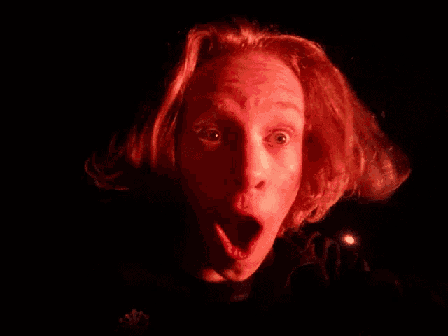 a close up of a person 's face with a surprised expression