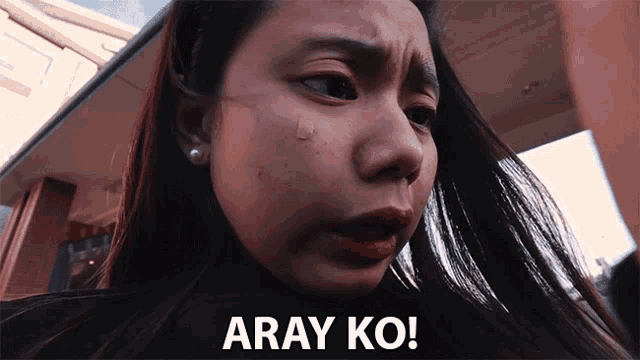 a close up of a woman 's face with the words " aray ko " on the bottom