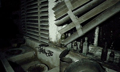a dark room with a few bottles and a sink